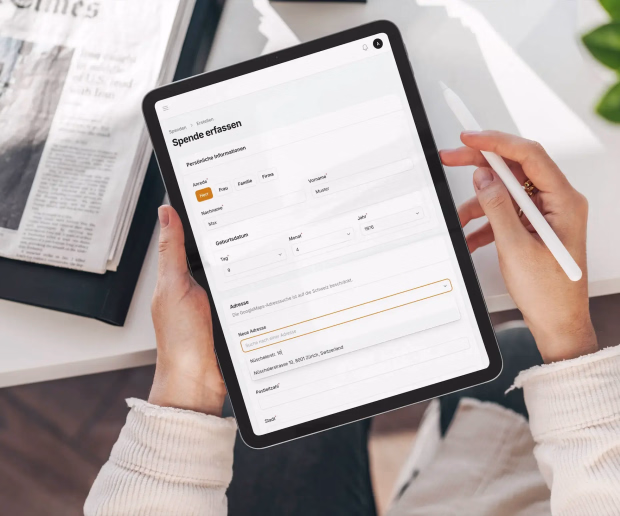 Tablet displaying a donation recording form with donor personal information and address fields