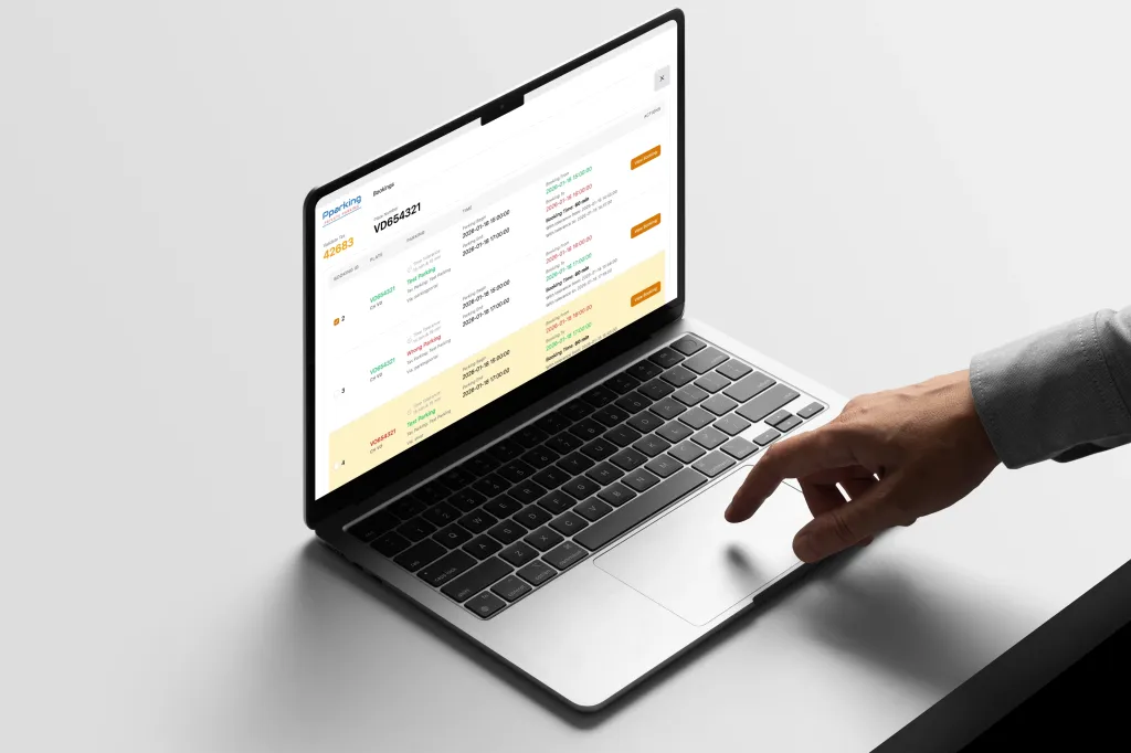 Laptop showing a Pparking dashboard with vehicle bookings and license plate tracking.