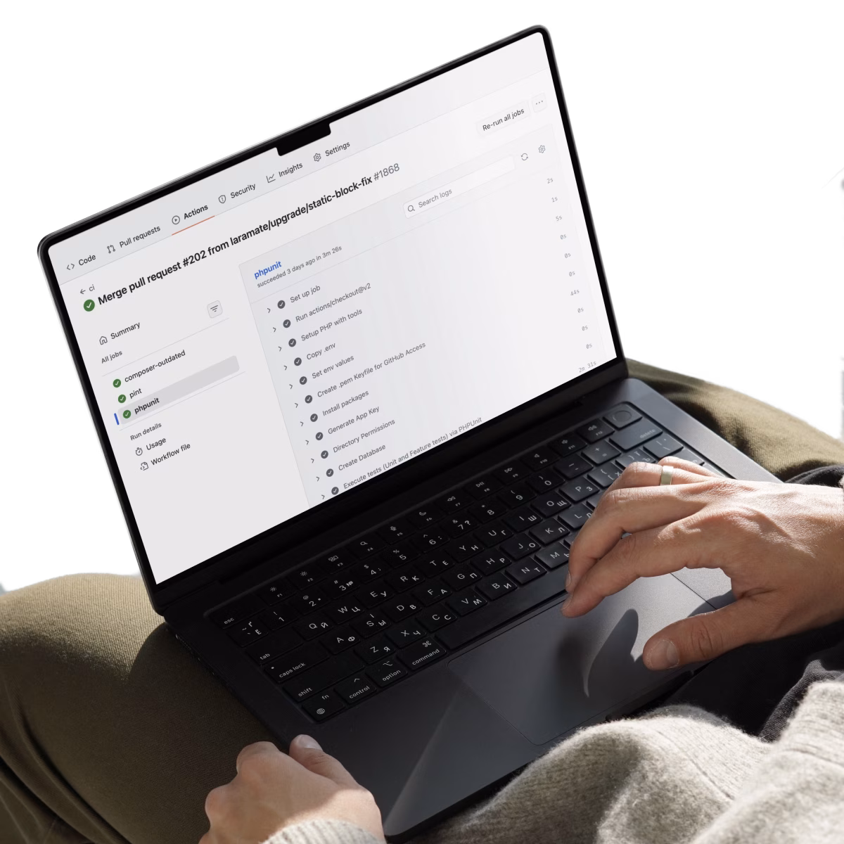 Laptop showing a GitHub Actions CI/CD pipeline with successful PHPUnit test results