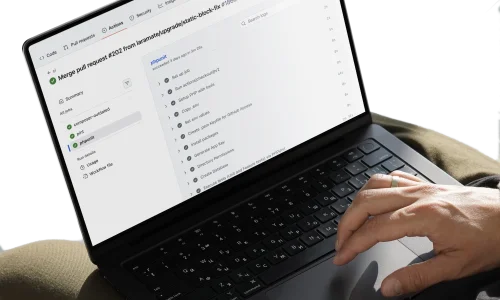 Laptop showing a GitHub Actions CI/CD pipeline with successful PHPUnit test results