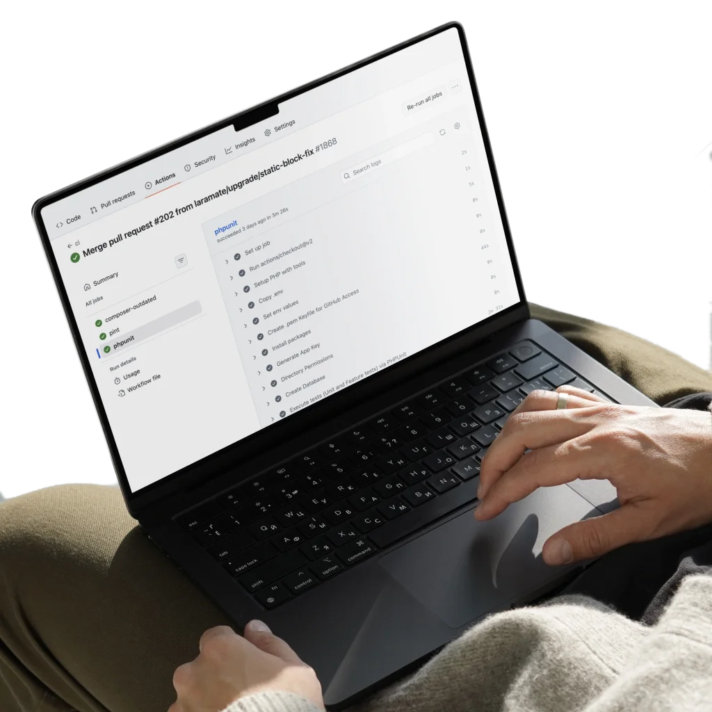 Laptop showing a GitHub Actions CI/CD pipeline with successful PHPUnit test results.