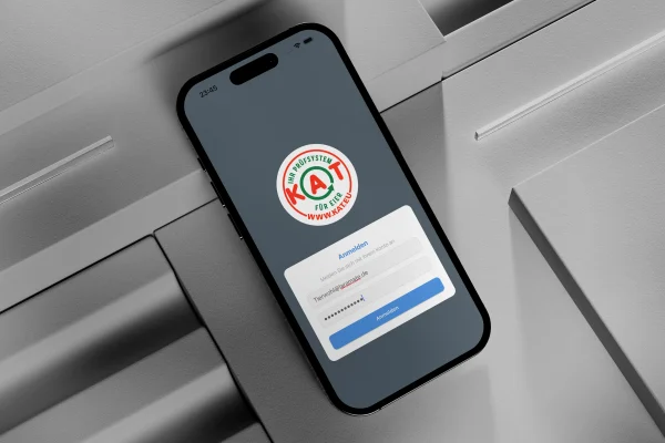 Smartphone showing a KAT certification app login screen for quality assurance