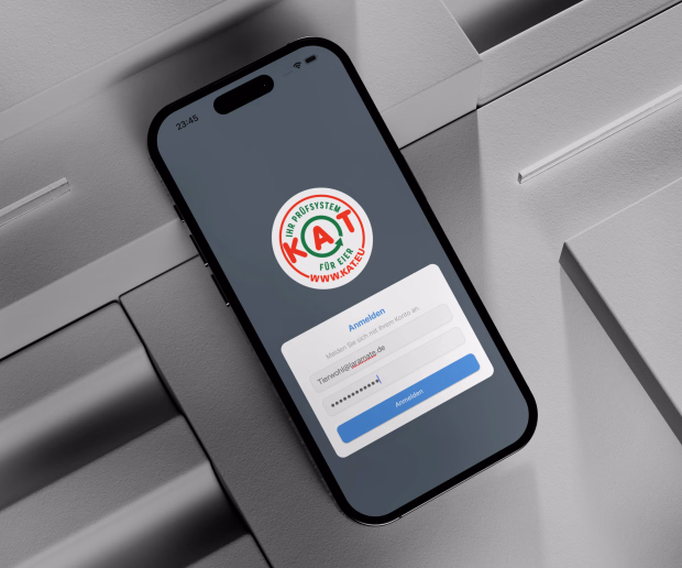 Smartphone showing a KAT certification app login screen for quality assurance