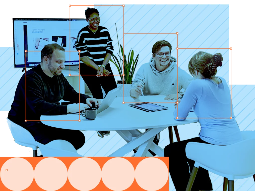 Laramate team collaborating at a meeting table in the office.