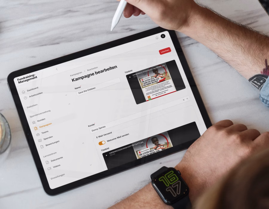 Tablet displaying a fundraising campaign management interface with campaign editing tools