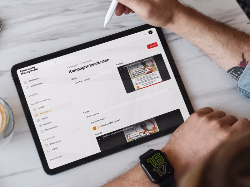 Tablet displaying a fundraising campaign management interface with campaign editing tools