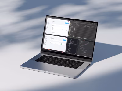 Laptop showing Statamic multi-tenant CMS setup with code editor and content management panels